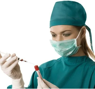 Medical professional in surgical mask holding syringe and blood sample tube